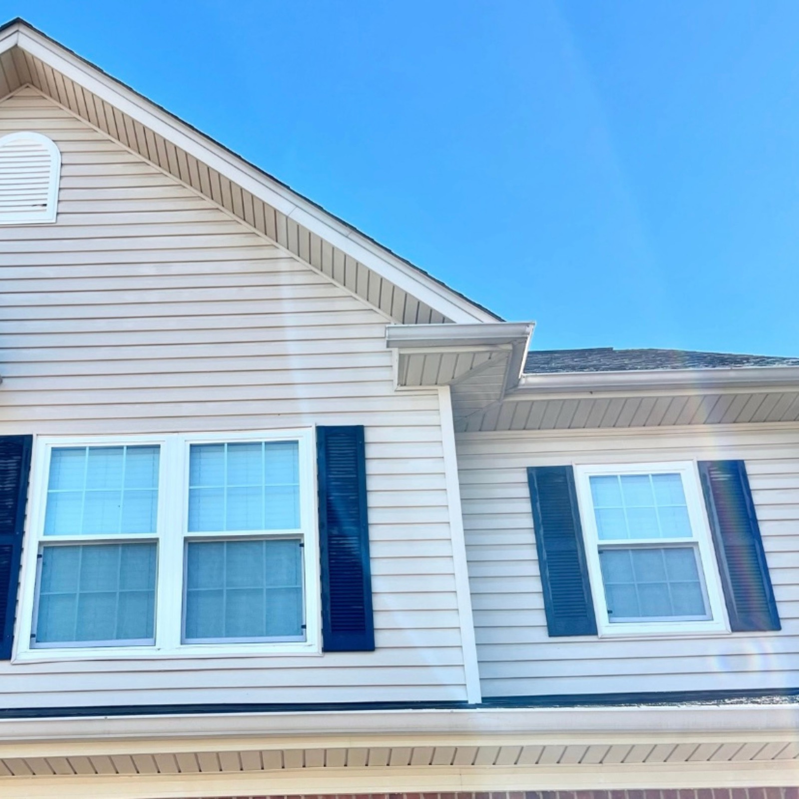 Clean home exterior with blue shutters