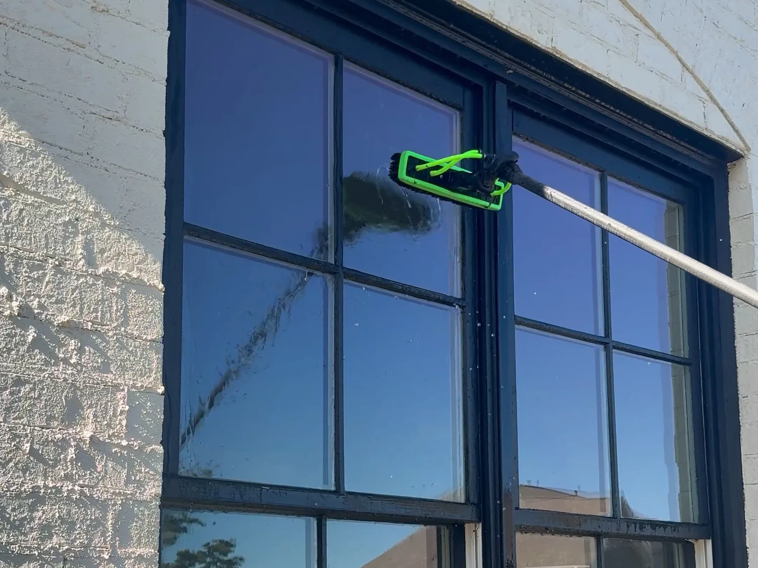 Cleaning a window with a pure-water-fed pole