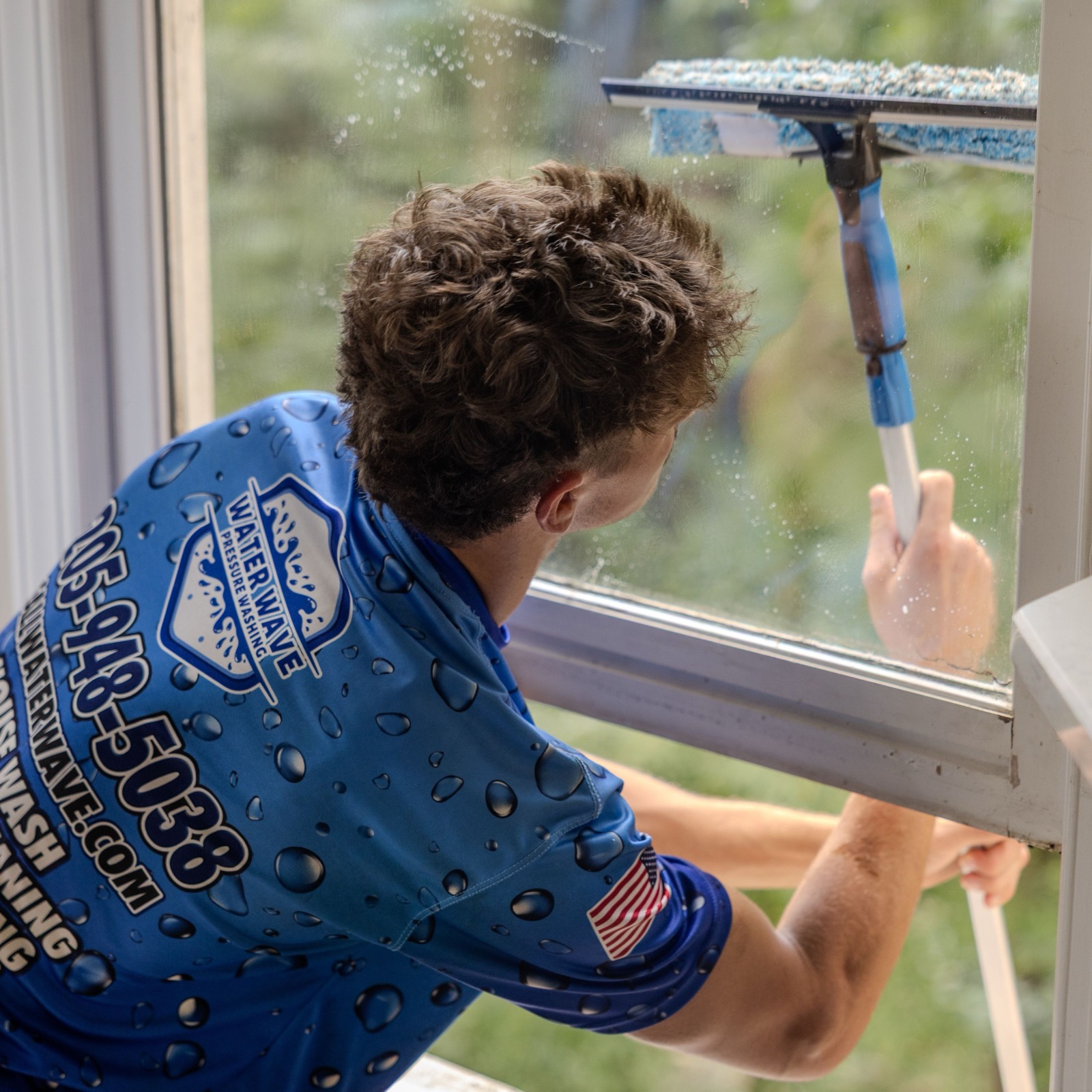 Squeegee cleaning a large window